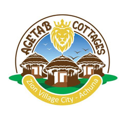 Logo of Agetab Cottages featuring three traditional thatched huts with birds flying and a lion's head above. Text reads "Agetab Cottages" and "Zion Village City - Achuna" on a ribbon below.
